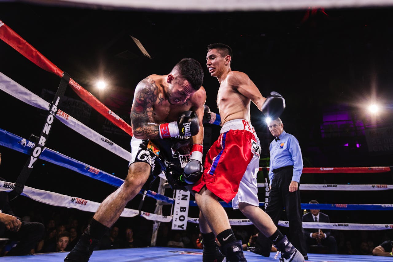 A dynamic scene of two boxers in action during a fierce match in the boxing ring.